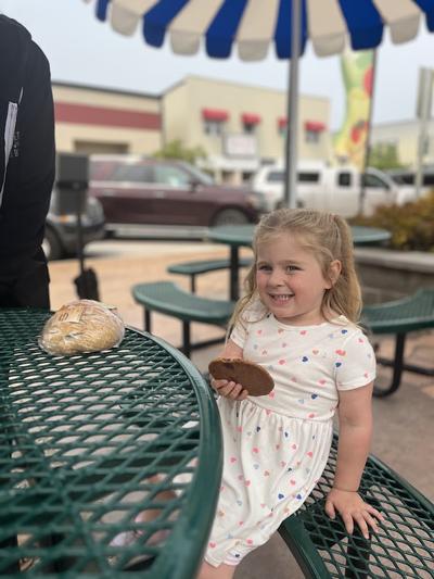 A young girl enjoys a cookie